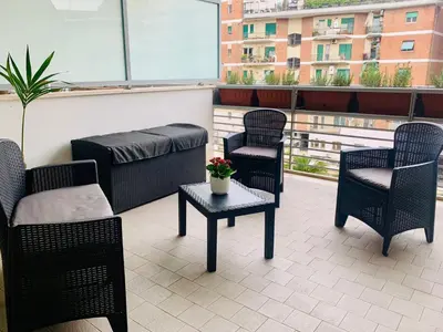 a group of chairs and tables on a balcony at PortamiPortese Trastevere Terrace in Trastevere