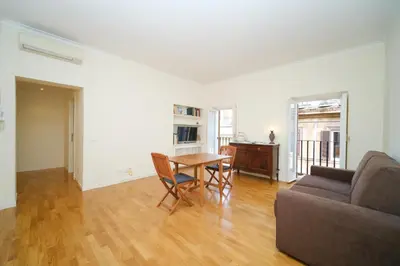 a living room with a table and a couch at Elisa's Trevi Fountain BuddyRent in Rome