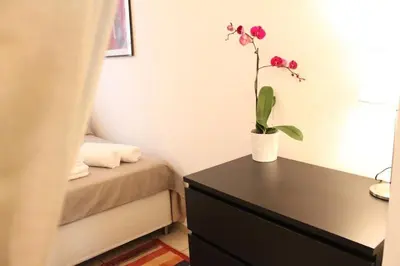 a bedroom with a table with a potted plant on it at Maison Yassi Piazza del Popolo in Rome