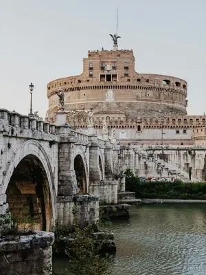 a bridge over a river with a building at Maison Yassi Piazza del Popolo in Rome