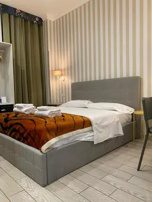 a bedroom with a bed in a room at Rome Orange Inn in Rome