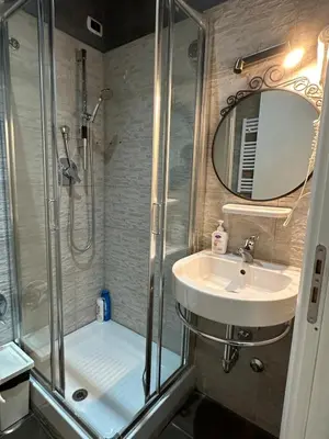 a bathroom with a shower and a sink at Rome Orange Inn in Rome