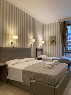a hotel room with two beds with towels on them at Rome Orange Inn in Rome
