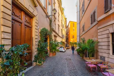 a person walking down a street in an alley at Central Charm near Piazza Navona - Cozy Loft for 2 in Rome
