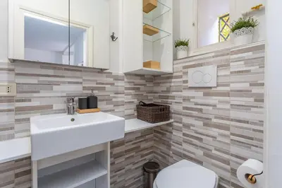 a bathroom with a sink and a toilet at Central Charm near Piazza Navona - Cozy Loft for 2 in Rome