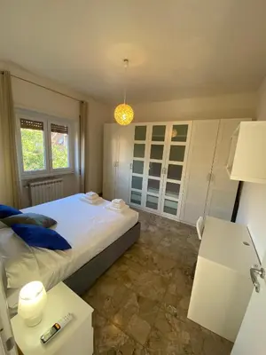 a bedroom with a large bed and a lamp at CASA BALU' in Rome
