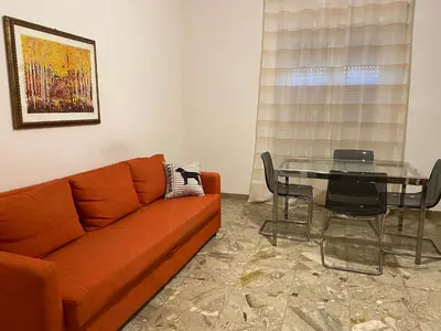 a living room with a couch and a glass table at CASA BALU' in Rome