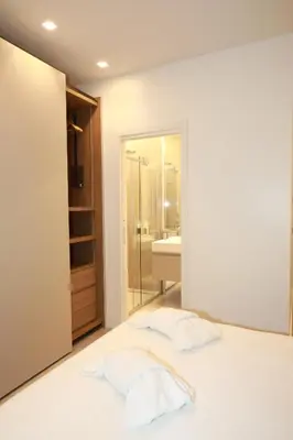 a bedroom with a bed and a bathroom at Unique Luxury Stay in Rome