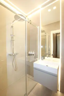 a white bathroom with a sink and a shower at Unique Luxury Stay in Rome