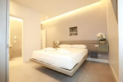 a white bedroom with a large white bed in it at Unique Luxury Stay in Rome