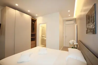a bedroom with a white bed with two white pillows at Unique Luxury Stay in Rome