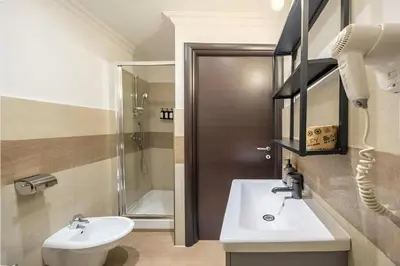 a bathroom with a sink and a toilet and a shower at Ghetto BuddyRent in Rome