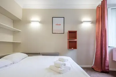 a bedroom with a bed with towels on it at Ghetto BuddyRent in Rome