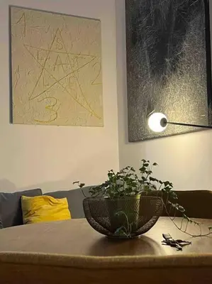 a table with a potted plant on top of it at Lovely art&design 2 bdrms flat in Rome