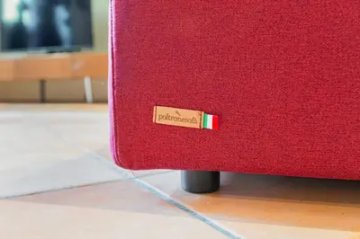 a red suitcase sitting on the floor with a tag on it at Historia et Elegantia - vicino il Colosseo, Circo Massimo e Trastevere in Rome