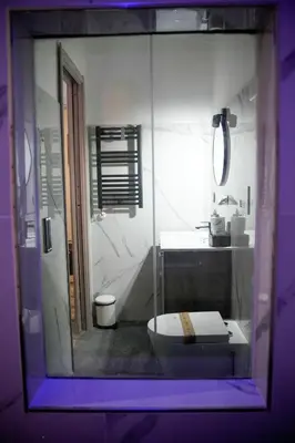 a bedroom with a large bed with purple lighting at Matriosca Suites in Rome