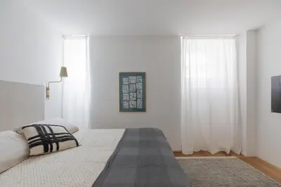 a white bedroom with a bed and a tv at Saint Peter Caesar Suites in Rome