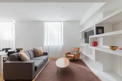 a living room with a couch and a chair at Saint Peter Caesar Suites in Rome
