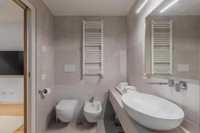 a bathroom with a white sink and a toilet at Saint Peter Caesar Suites in Rome