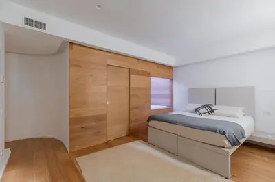 a bedroom with a bed in a room with wooden walls at Saint Peter Caesar Suites in Rome
