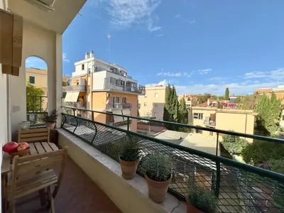 a white bedroom with a large bed and a window at Interno 4 in Rome - Aventino e Circo Massimo in Rome