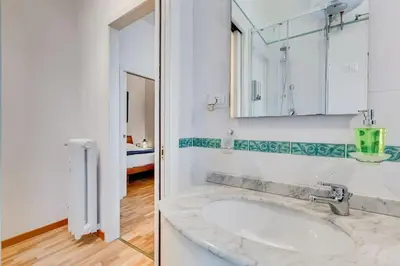 a bathroom with a sink and a mirror at Clemente XII Al Quirinale House in Rome