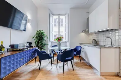 a kitchen with a table and chairs in a kitchen at Clemente XII Al Quirinale House in Rome