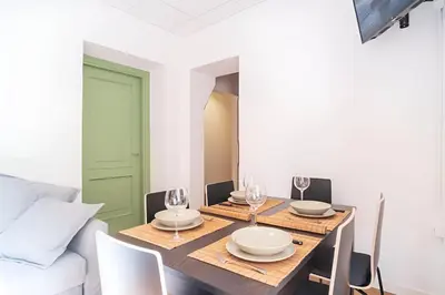 a dining room with a wooden table and chairs at Trevi's BuddyRent in Rome