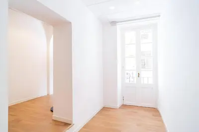 an empty room with white walls and wooden floors at Trevi's BuddyRent in Rome