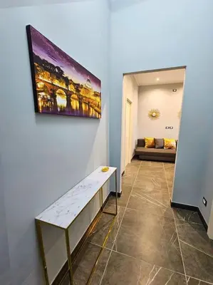 a room with a painting hanging on the wall at Domitia Vatican Luxury Apartment in Rome