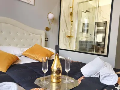 a bedroom with a bed with a bottle and two glasses at Domitia Vatican Luxury Apartment in Rome
