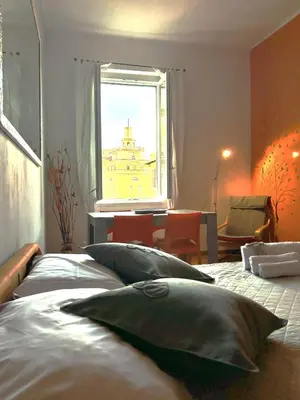a bedroom with a bed with pillows in front of a window at Appartamento Residenza Girasole Vatican in Rome