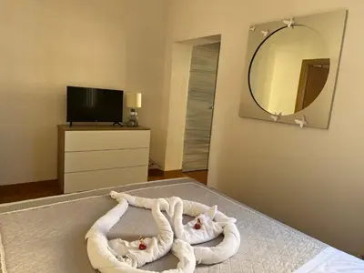 a room with two towels on a bed with a mirror at Appartamento Residenza Girasole Vatican in Rome