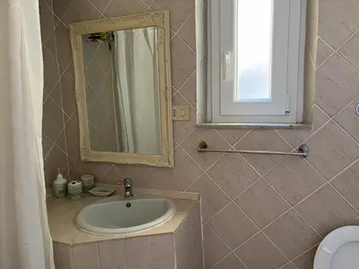 a bathroom with a sink and a mirror at Appartamento Residenza Girasole Vatican in Rome