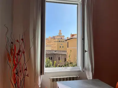 a window with a view of a city at Appartamento Residenza Girasole Vatican in Rome