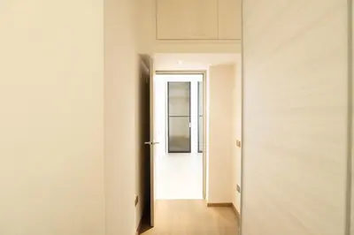 a hallway with a white door and a mirror at Gabbo - House in Rome