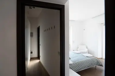 a mirror in a room with a bed and a bedroom at Gabbo - House in Rome
