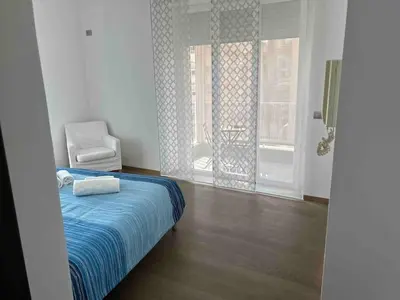a bedroom with a bed and a chair and a window at Gabbo - House in Rome