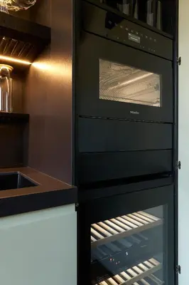 a black oven with its door open in a kitchen at Casa MastroiannI con Terrazzo in Rome