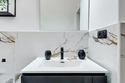 a bathroom with a white sink and a mirror at Salotto San Pietro in Rome