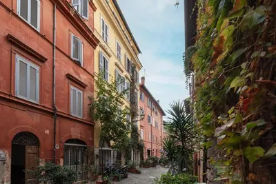 an alley in an old town with buildings at GuestHost - Trastevere Leopard'Oro Apartment in Rome