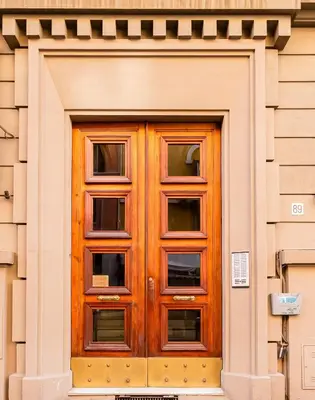 a wooden door on the side of a building at CasaVibe Vaticano in Rome