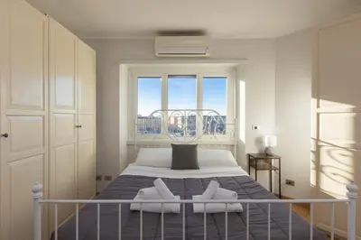 a bedroom with a bed with two white towels on it at Piramide view by Rental in Rome in Rome