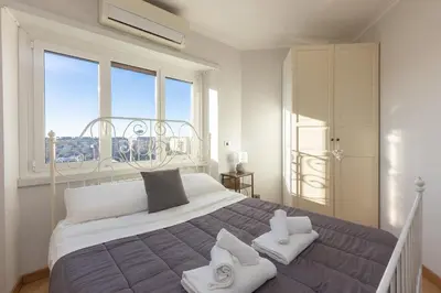 a bedroom with a large bed with white towels on it at Piramide view by Rental in Rome in Rome