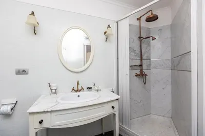 a white bathroom with a sink and a shower at Piramide view by Rental in Rome in Rome