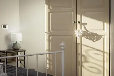 a door in a room with a lamp and a table at Piramide view by Rental in Rome in Rome