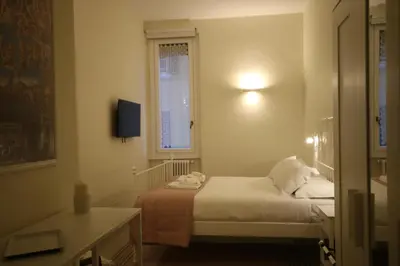 a small room with a bed and a window at Irene's Home The Retreat in Rome