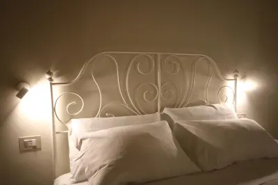 a white bed with white sheets and pillows at Irene's Home The Retreat in Rome