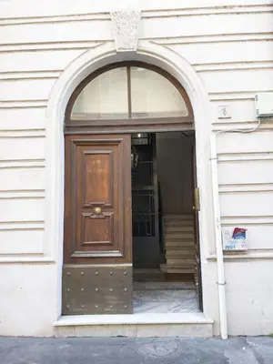 an entrance to a building with a wooden door at Irene's Home The Retreat in Rome