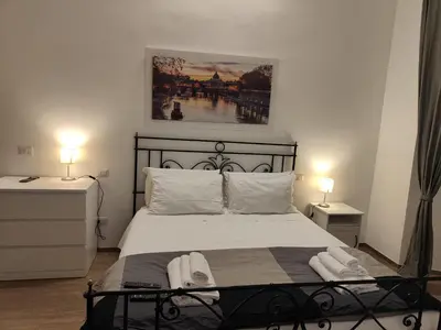 a bedroom with a bed with two towels on it at White King Rooms in Rome